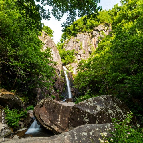 Waterfall cascading down rocky gorge