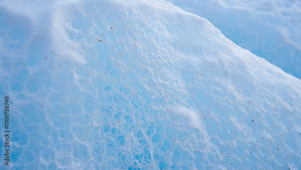 Obraz premium A closeup abstract view of the textured surface of a glacier, revealing intricate patterns of ice and water with a vibrant blue hue