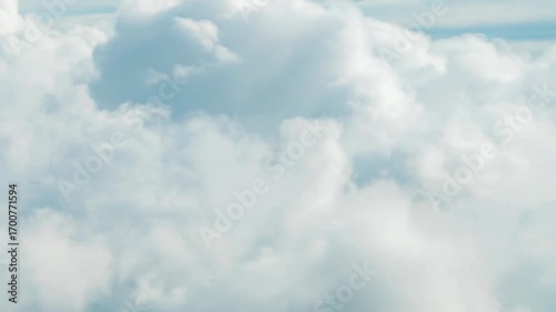 A beautiful aerial view of fluffy white clouds against a light blue sky