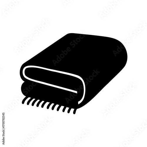 Folded black blanket or throw with tassels on a white background