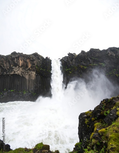 Waterfall cascading over basalt cliffs
