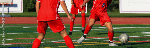 Soccer Players Engaged in an Exciting Match on a Turf Field
