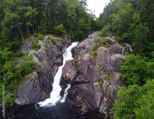 Waterfall cascading over rocky terrain in a lush forest