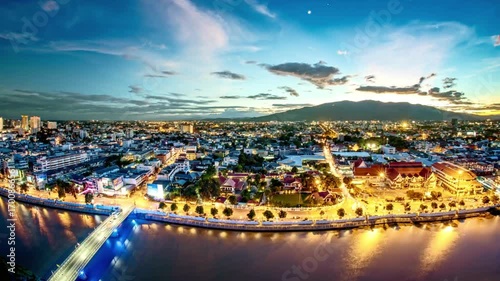 Aerial view of chiang mai city at twilight with ping river and bridge, thailand