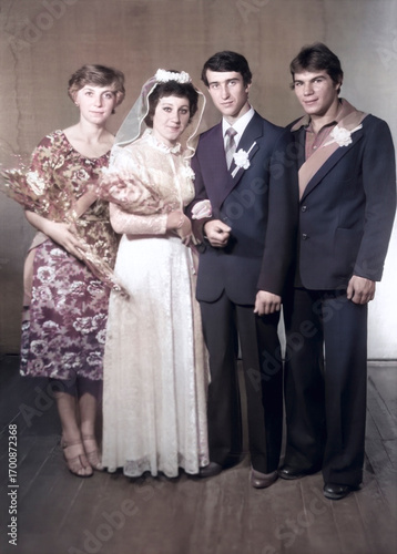 Lozovaya, UkrSSR, USSR - circa 1980: Vintage portrait of the bride and groom and their witnesses after the wedding. Retro photo