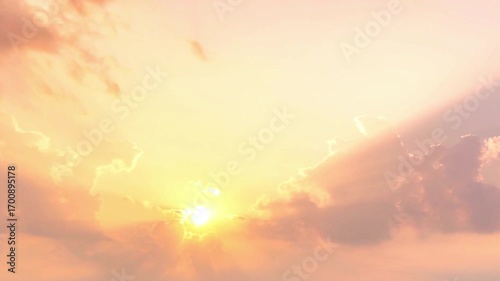 Golden sunset with sun rays shining through clouds creating a peaceful atmosphere