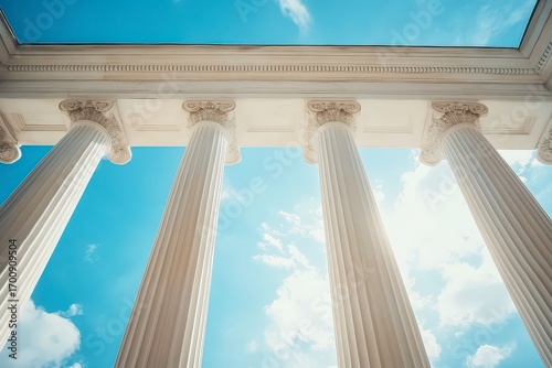 The four pillars are white and are part of a building