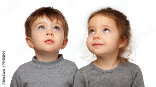boy with inquisitive look gazing upward against ultrabright white background embodies sense of anticipation