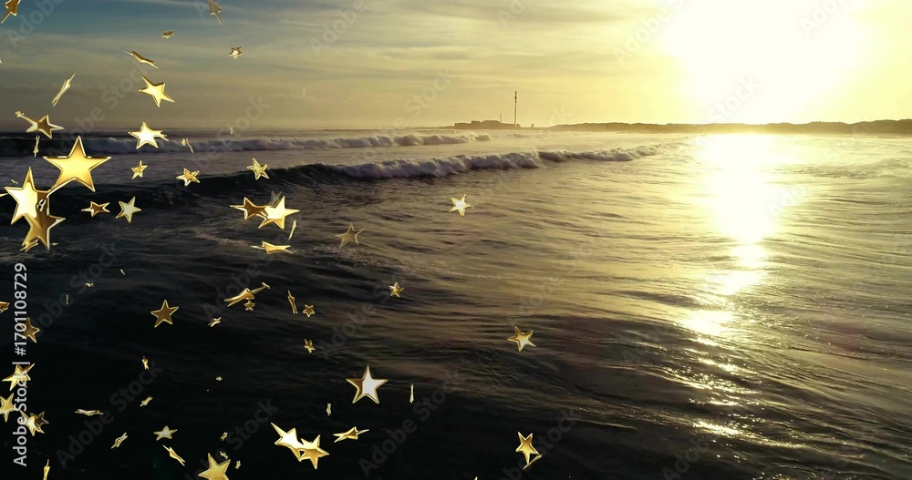 Obraz premium Rolling ocean waves reflecting golden light along coast at sunset, with tower and star overlays
