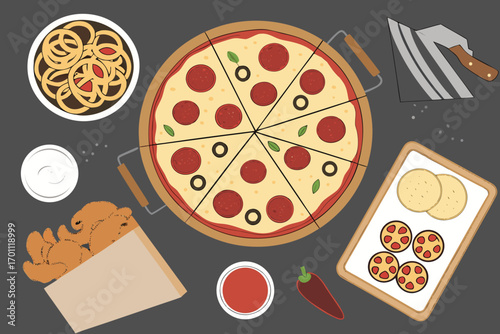 Overhead view of a pepperoni pizza with olives and basil slices surrounded by fried onion rings, chicken nuggets, dipping sauce, and crackers