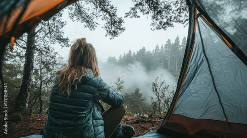 Woman outdoors camping misty forest