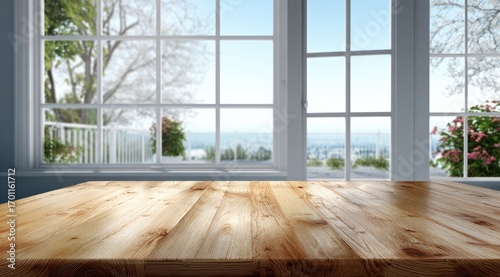 Wooden tabletop in front of a large window with a scenic outdoor view