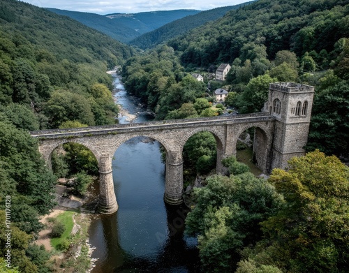 Old Stone Bridge Over River in Green Valley