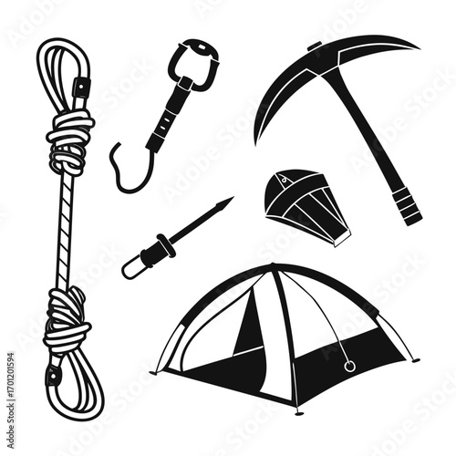 Collection of outdoor adventure and camping equipment including a coiled rope carabiner ice axe tent and other gear for extreme sports and expeditions