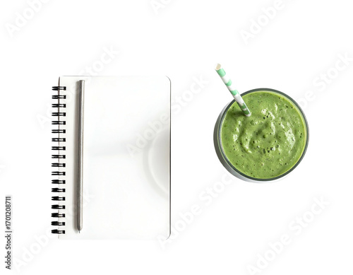 Healthy green smoothie and notepad