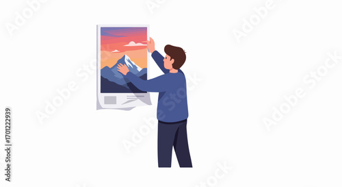Man hanging a vibrant mountain landscape poster on a wall, depicting home decoration and personalizing living space with art.