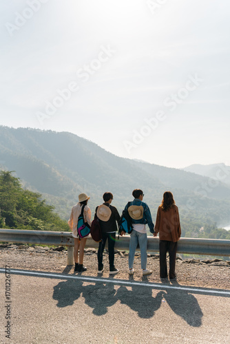 Happy Young Asian man and woman road trip travel nature countryside on summer holiday vacation. Generation z people friends enjoy outdoor lifestyle looking beautiful nature of forest mountain together