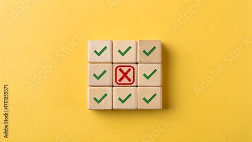 3x3 grid of wooden blocks with green check marks and central red X on yellow background – Conceptual metaphor for conformity, exception, and error detection in group validation, business, abstract