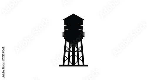 a water tower stands tall against clear sky silhouette