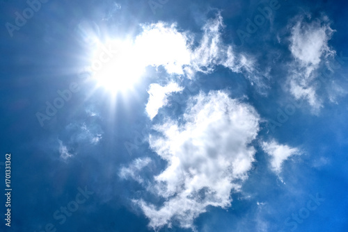 Hot steaming sun over white cloud in tropical Indonesian sky