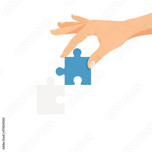 A hand carefully places a blue jigsaw puzzle piece into its matching white counterpart.