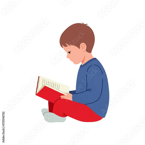 A young boy engrossed in reading a book, seated on the floor