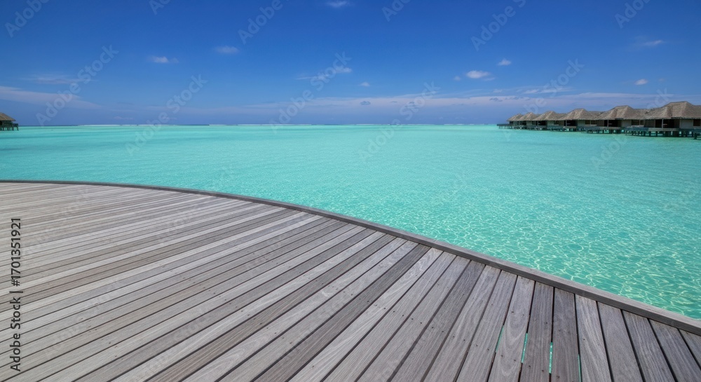 Naklejka premium Turquoise water and blue sky viewed from a wooden deck