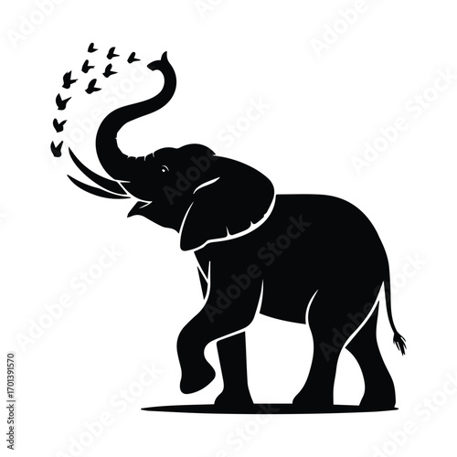 Majestic elephant with raised trunk and flock of birds taking flight symbol of nature