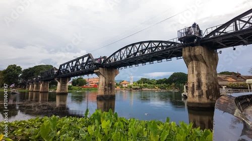 Stunning Timelapse of Iconic River Kwai Bridge in Kanchanaburi Lush Greenery, Serene Water Reflections, and Scenic Atmosphere