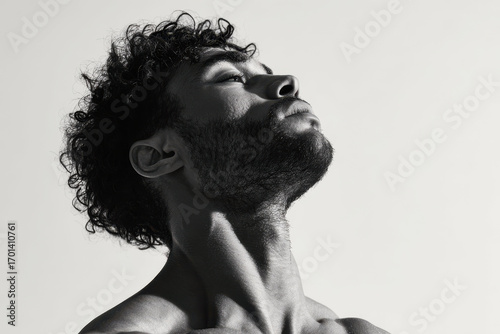 side profile of young man with tense neck during dumbbell workout intensity of his effort