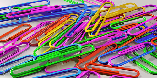 Colorful paperclips scattered randomly on a white background, showcasing a variety of bright hues and overlapping arrangements.