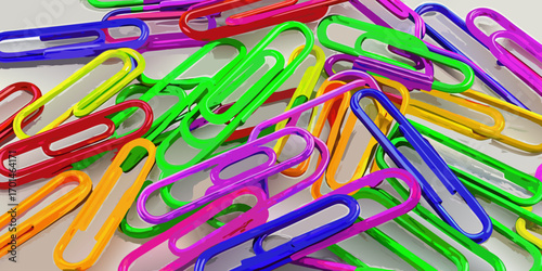 Colorful paperclips scattered randomly on a white background, showcasing a variety of bright hues and overlapping arrangements.