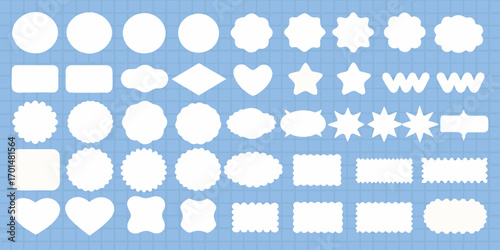 Collection of diverse white decorative shapes and labels on a blue grid background