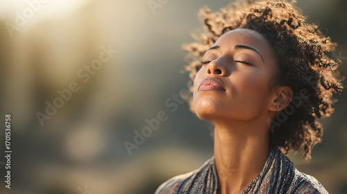 Peaceful African American woman meditating outdoors, eyes closed in serene prayerful pose, soft natural sunlight, calm nature background