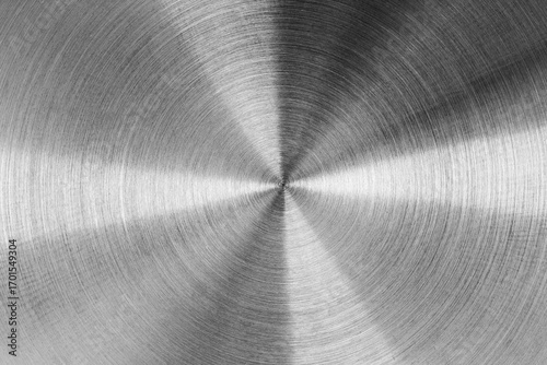 Circular brushed metal texture, silver metallic background.