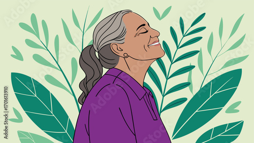A senior woman with gray hair tied in a ponytail smiles with her eyes closed, surrounded by lush green leaves, embodying peace and nature
