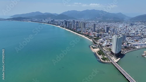 Aerial panoramic view of Southern part of Nha Trang city with coastal road, sand beach and mountains, Vietnam.