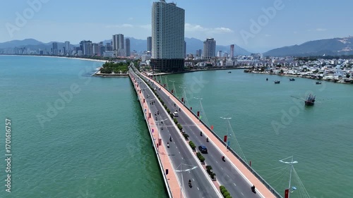Aerial view of Cau Tran Phu bridge across Cai river and Southern part of Nha Trang city with beach, Vietnam.