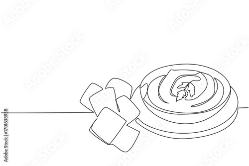 Single continuous line drawing hummus in a black bowl on a round wooden cutting board with pita chips. Traditional Middle Eastern food. International Hummus Day. One line design vector illustration