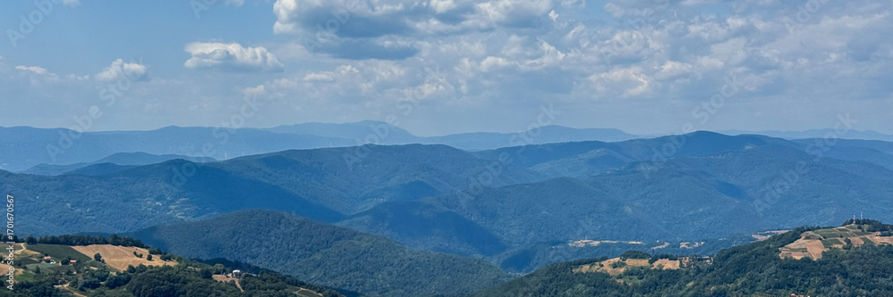 Obraz premium Expansive azure mountain vista, whispering tales of hidden valleys; perfect for Sky Appreciation Day and National Landscapes Week