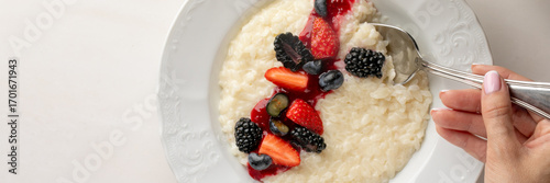 Creamy rice pudding adorned with vibrant berries evokes Midsummer sweetness, Nordic celebrations, and whimsical culinary artistry