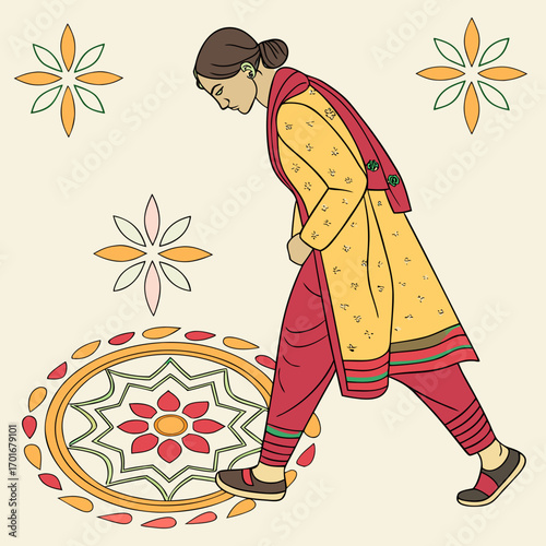 Woman in traditional indian clothing making a rangoli design