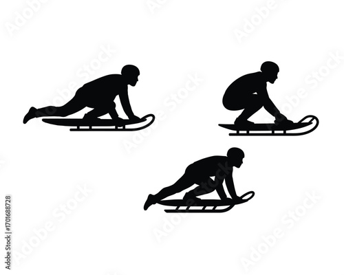 Dynamic black silhouettes of people sledding downhill on a snowy winter day
