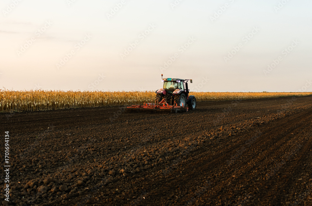 Fototapeta premium Tractor preparing the land for a new crop planting