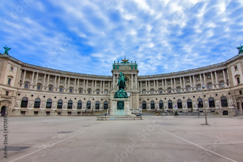 A breathtaking view of the historic Hofburg Palace, specifically the Neue Burg wing, and the iconic Heldenplatz in Vienna