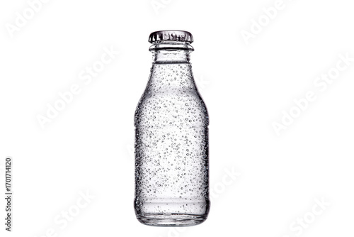 A clear glass bottle with a cap on top. The bottle is empty and has a lot of water droplets on the outside