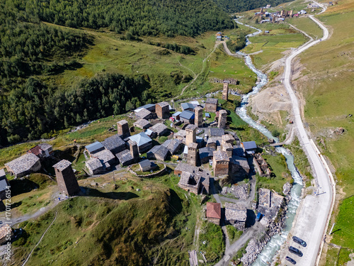 Aerial view of Mestia showing Svan towers, houses, and a flowing river in Georgia