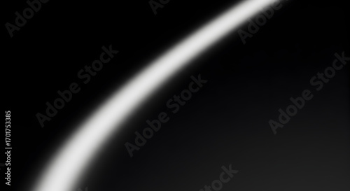Monochrome abstract background with a soft, curved white line on black.