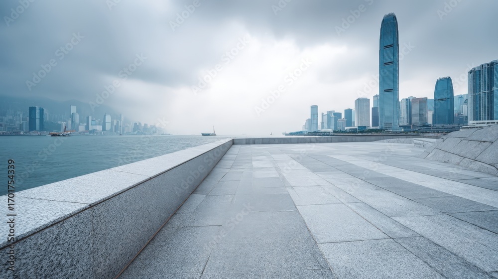 Fototapeta premium Urban Skyline View with Empty Terrace: Hong Kong Cityscape under Overcast Sky offering Modern Architectural Perspective