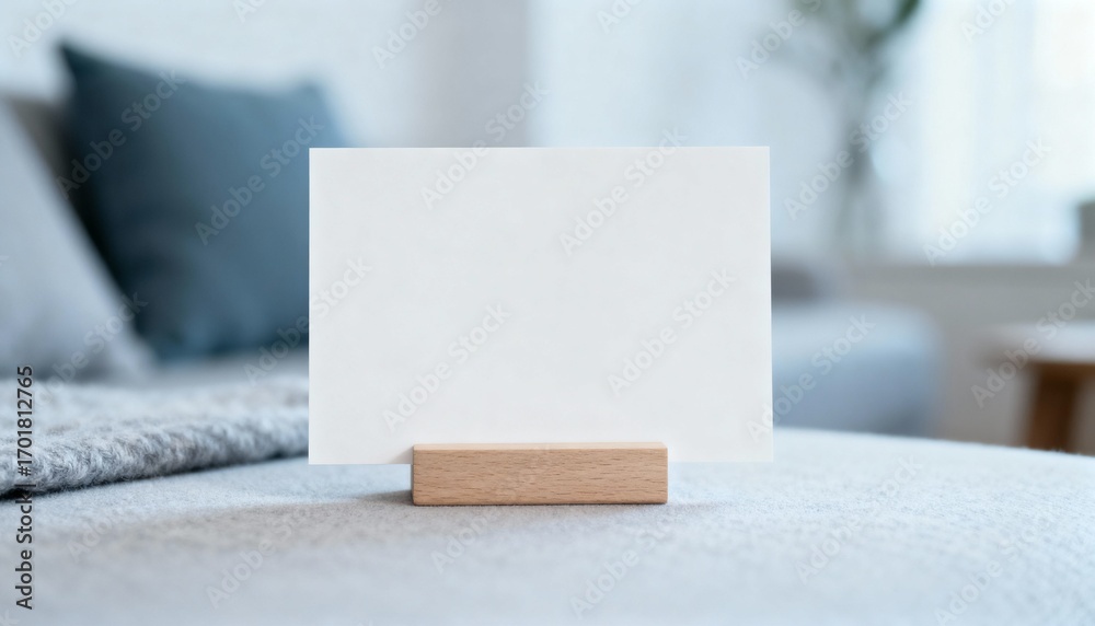 Fototapeta premium Blank White Card Mockup on Wooden Stand for Personalized Messages in Home Interior